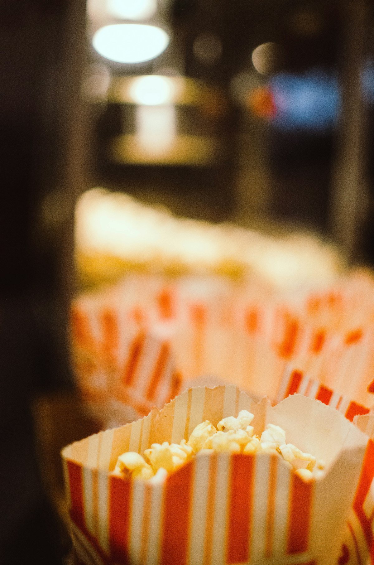 Popcorn in striped paper bags at a cinema