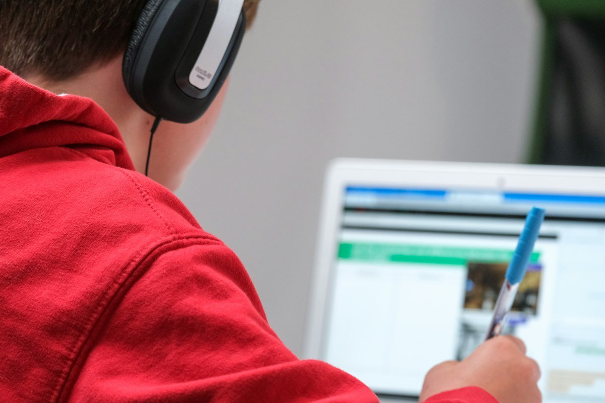 A person wearing headphones for an online class