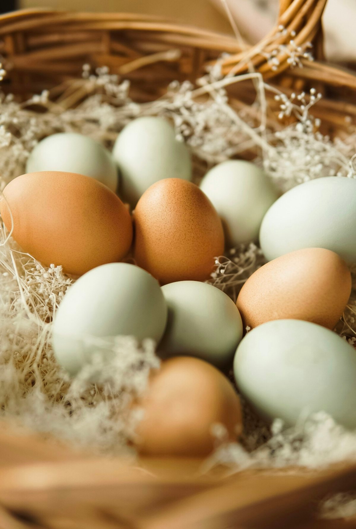 A basket filled with brown and white eggs